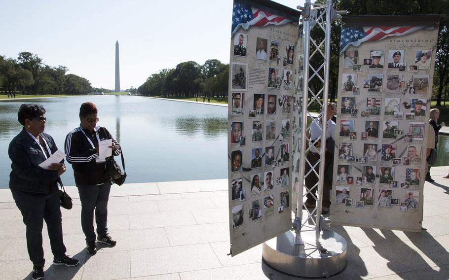 Two Gold Star Family members look at one of the panels on "Remembering Our Fallen," a traveling tribute to those who have died since 9/11 in the war against terrorism, Sept. 7, 2017 at the Lincoln Memorial in Washington, D.C.