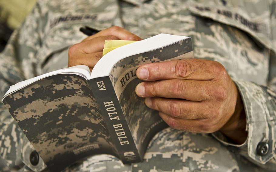 An Air Force chaplain reads from his Bible during a training scenario on Aug. 19, 2017. Air Force Capt. Sonny Hernandez, a chaplain with the 445th Airlift Wing at Wright-Patterson Air Force Base in Ohio, is under fire for saying that Christian servicemembers should not support the rights of other religions to practice their faith, saying “that will lead them to hell.”