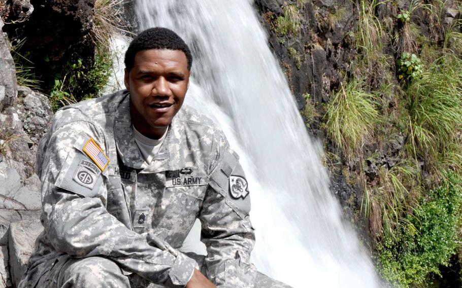 In this June 6, 2015 photo, U.S. Army National Guard Sgt. 1st Class Charleston Hartfield of the 100th Quartermaster Company poses for a photo at Rainbow Falls near Hilo, Hawaii. Hartfield was one of the people killed in Las Vegas after a gunman opened fire on Sunday, Oct. 1, 2017, at a country music festival.