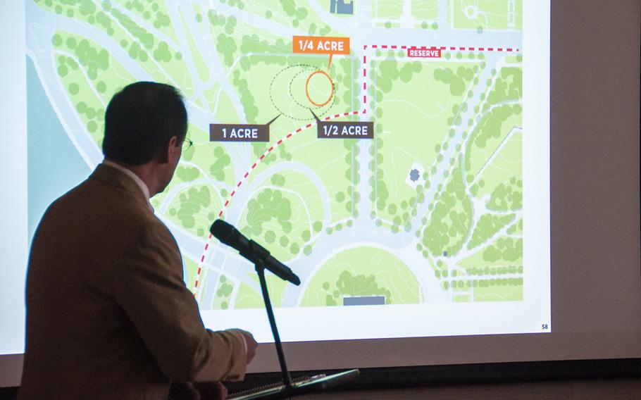 Alan Harwood, an excutive with the AECOM design firm working with the National Desert Storm and Desert Shield Memorial group, makes a presentation for the possible sites for a memorial during a hearing before the U.S. Commission of Fine Arts in Washington, D.C., on Thursday, Oct. 19, 2017. The slide displayed on the screen shows the memorial group's preferred site on the corner of Constitution Ave and 23rd Street.