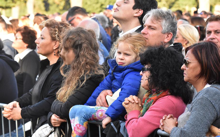 A family watches Pope Francis say an All Souls Day Mass to honor war dead Thursday Nov. 2, 2017 at the Sicily-Rome American Cemetery in Nettuno, Italy.