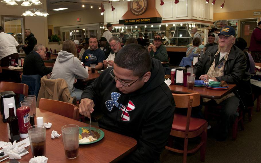 In a 2013 file photo, veterans enjoy a free meal at a Golden Corral restaurant in Fort Wayne, Ind., on Veteran's Day. The chain is one of many offering special deals to veterans this year.