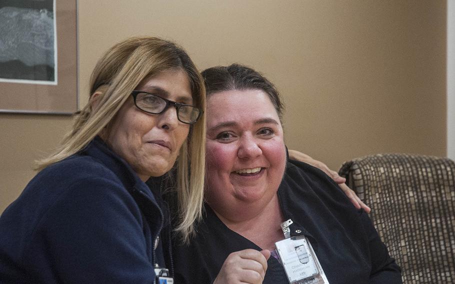 Carmen Garcia, left, a registered nurse at the Veterans Affairs Medical Center in San Juan, Puerto Rico, hugs licensed practical nurse Charity Haddican on Wednesday, Nov. 8, 2017, to show appreciation for her volunteer work at the hospital.