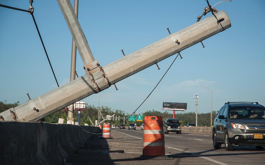A series of power poles lie across a concrete barrier along Highway 22, one of Puerto Rico's main East-West arteries, near the Toa Alta exit west of the island's capital city San Juan on Nov. 13, 2017, nearly eight weeks after Hurricane Maria ravaged the island.