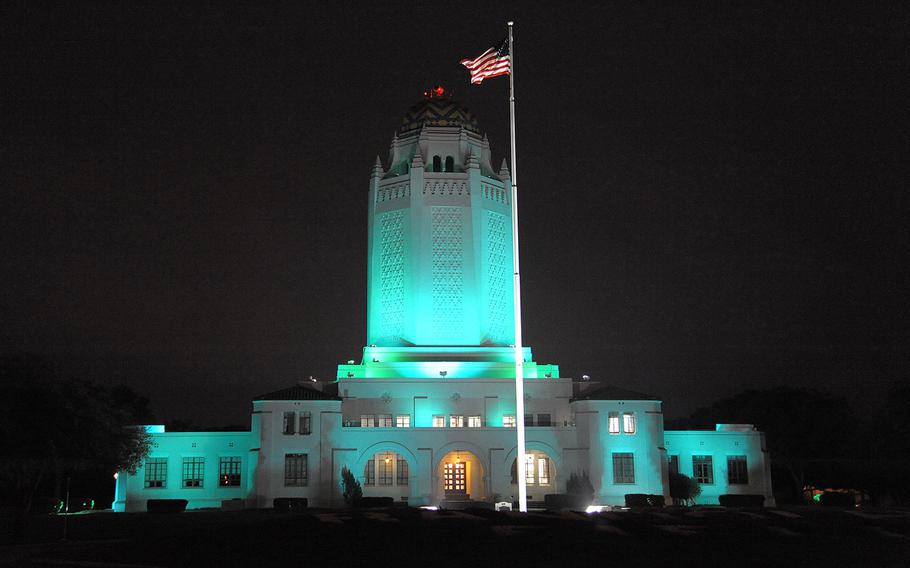 In an April, 2015 file photo, the Taj at Joint Base San Antonio-Randolph in Texas is bathed in teal lighting in recognition of Sexual Assault Awareness and Prevention Month.