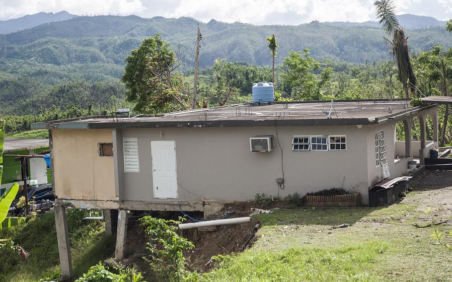 Next door to Ana Delia Figueroa's home, the upper level of a house, destroyed when Hurricane Maria struck in September, sits virtually bare in the Ciales region of Puerto Rico on Nov. 12, 2017, nearly eight weeks later. The foundation looks to be suffering as well.