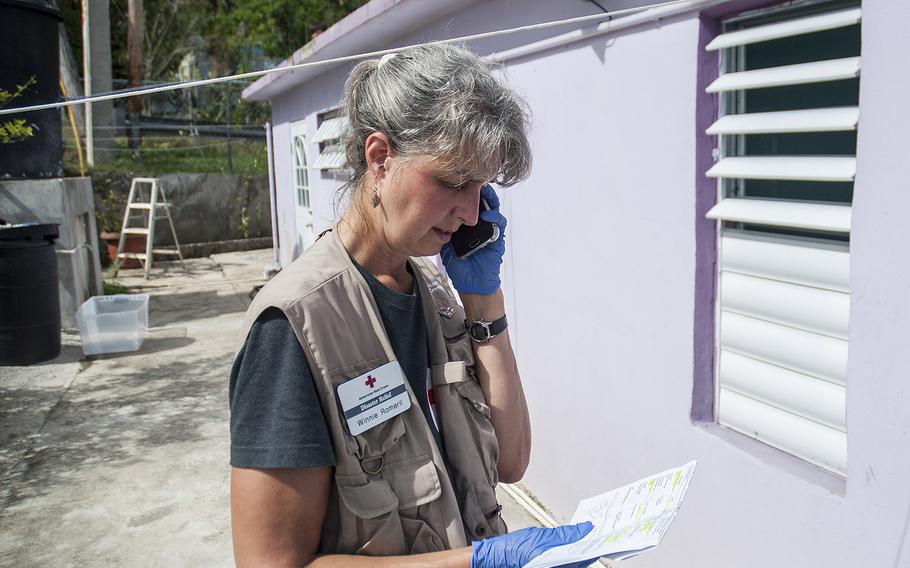 Red Cross disaster relief worker Winnie Romeril calls for an ambulance to the house of Korean War veteran Agostin Figueroa while visiting elderly residents in the Ciales region of Puerto Rico, on Nov. 12, 2017.