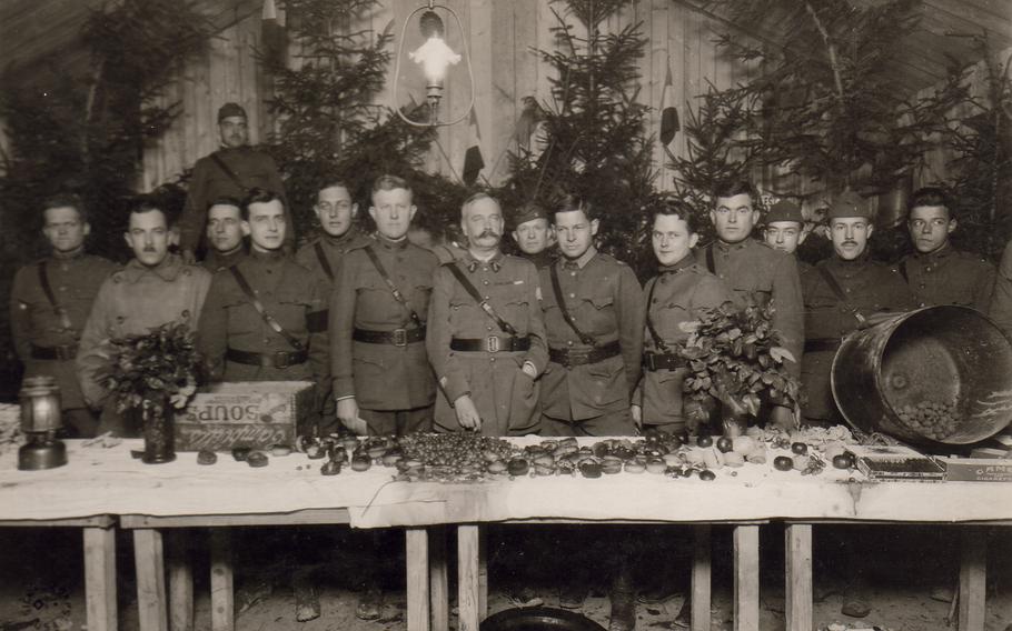 Officers of Headquarters 79th Division, who served cocoa, sandwiches, cake, orange, nuts, grapes, cigars, and cigarettes to enlisted men of Headquarters at Y.M.C.A. Christmas night. Dugny, Meuse, France. Dec. 25, 1918. 