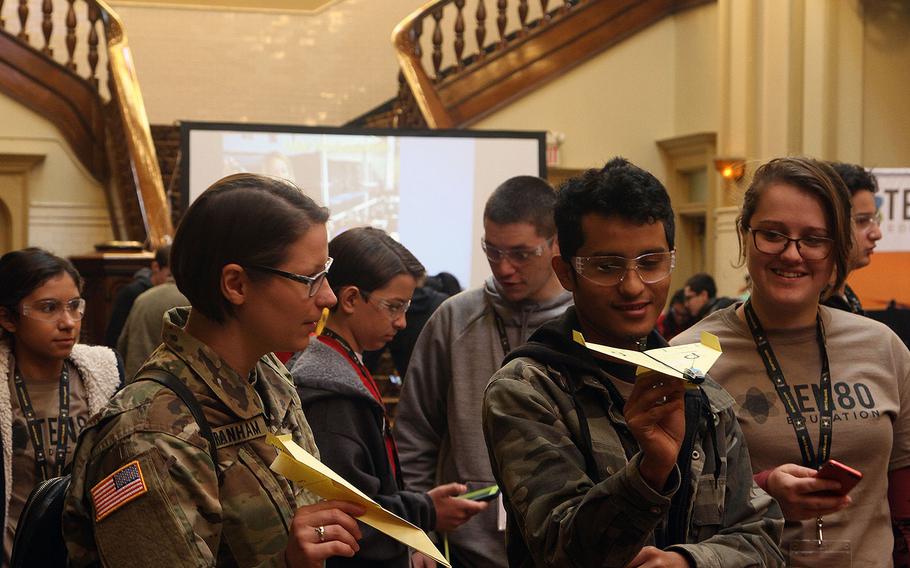 U.S. Army Reserve 1st Lt. Katherine Branham of the 41th Theatre Engineering Command compares her airplane with a high school STEM students during the U.S. Army All-American Bowl week Go Army Experience Zone Ten80 STEM workshop Jan. 5, 2018, at Sunset Station in San Antonio, Texas. Branham was invited to share her experience as an Army Reservists and how that translated into her civilian career during the event.