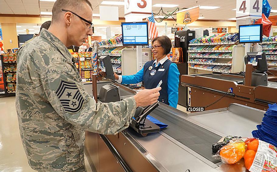Chief Master Sgt. Stuart Allison swipes a MILITARY STAR card at the commissary at Fort Lee in Virginia on Oct. 5, 2017.