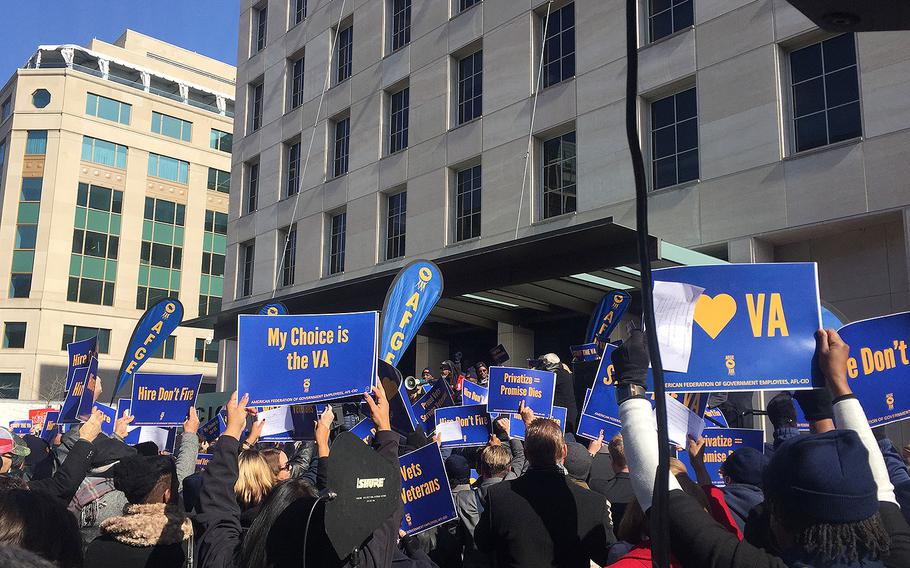 About 200 federal workers marched by Department of Veterans Affairs headquarters in Washington on Tuesday, Feb. 13, 2018, protesting staffing shortages and what they argued were attempts by President Donald Trump to dismantle the VA health care system.