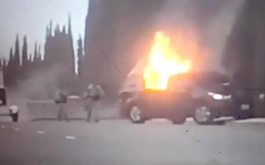 A vehicle is on on flames after crashing shortly after gaining access to Travis Air Force Base near Sacramento, Calif., on Wednesday, March 22, 2018. The driver was killed in the incident.