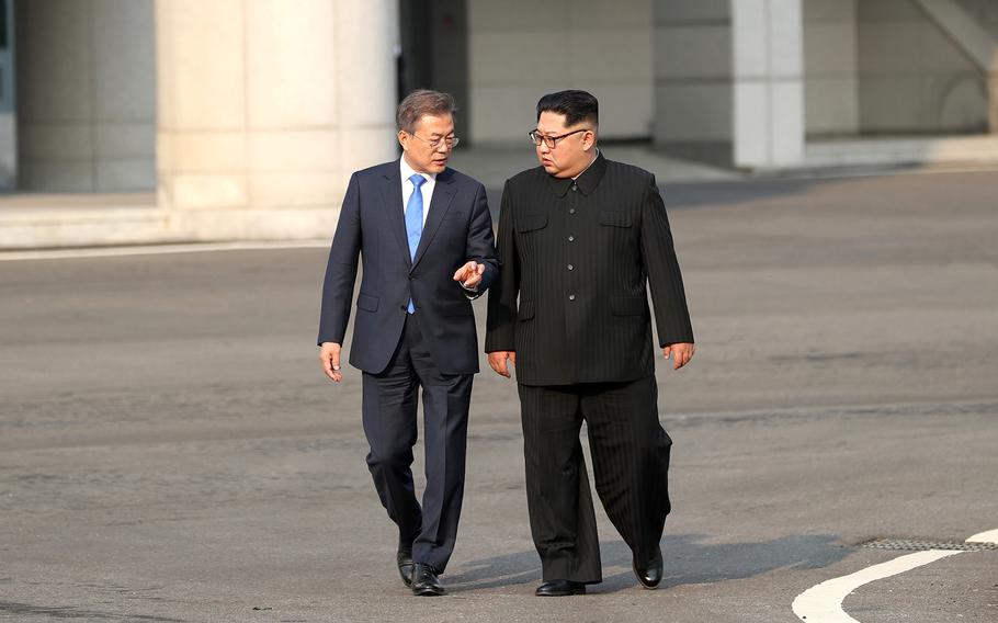 North Korean leader Kim Jong Un, right, walks with South Korean President Moon Jae-in during the Inter-Korean Summit on Friday, April 27, 2018.