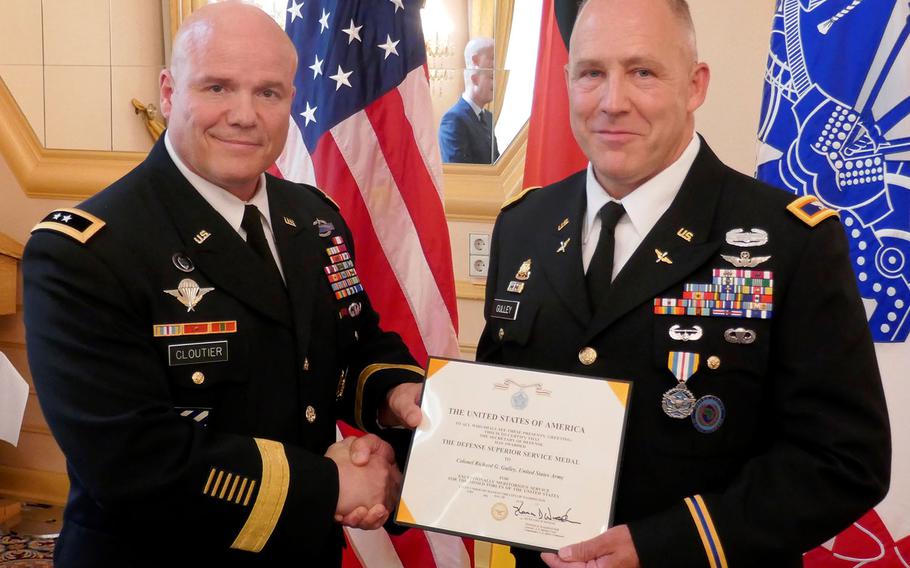 Maj. Gen. Roger Cloutier, U.S. Africa Command's chief of staff, left, stands with Col. Richard Gulley during Gulley's retirement ceremony in Stuttgart, Germany, on June 30, 2017. Gulley, along with numerous other reservists, says he was unfairly targeted by Army investigators over housing benefits.