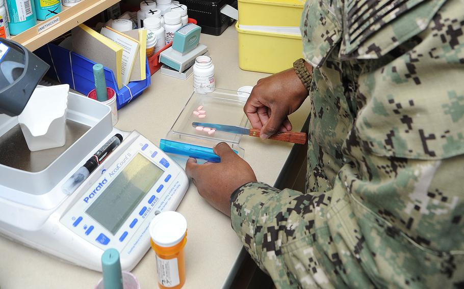 A certified pharmacy technician at Naval Hospital Pensacola fills a prescription on Dec. 6, 2017.