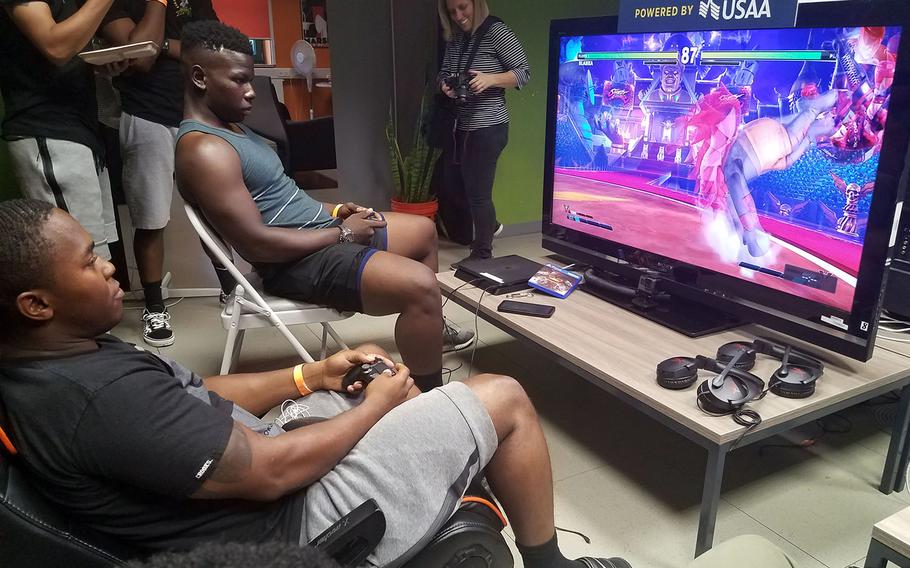 Sgt. Kalyntae Williams, top, and Sgt. Deveon Landfair, soldiers with the Army's Second Cavalry Regiment, play the final round of Street Fighter V, at the E-game tournament at Grafenwoehr, Germany, Saturday, July 28, 2018. Williams beat Landfair, and will now be traveling to Seattle to compete in the PAX West Gaming Convention. 