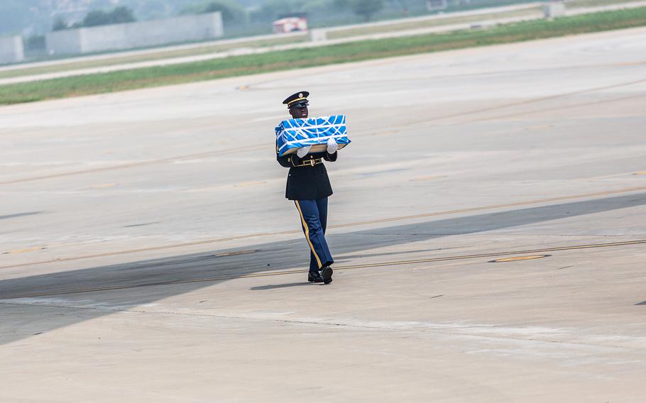 Staff Sgt. Jamil Green carries the final case of remains at Osan Air Base, South Korea, Friday, July 27, 2018.
