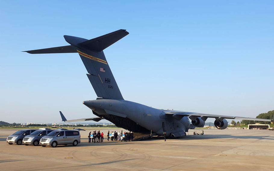 Remains recently handed over by North Korea are loaded onto an Air Force transport plane at Osan Air Base, South Korea, for their trip to Hawaii, Wednesday, Aug. 1, 2018.