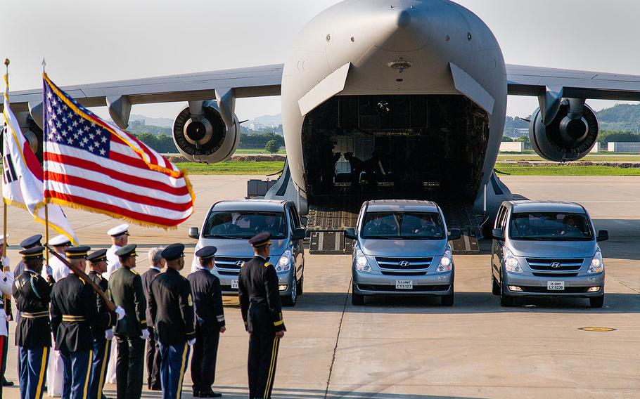 A casket is placed into an Air Force transport plane at Osan Air Base, South Korea, for the trip to Hawaii on Wednesday, Aug. 1, 2018.