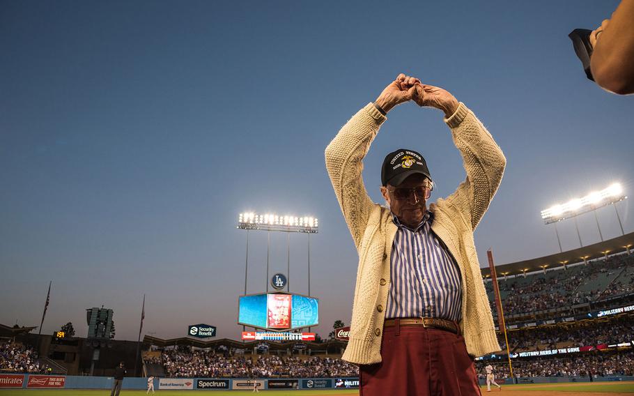 Marine veteran Sam Folsom, 98, who flew fighters at Guadalcanal in World War II, where he shot down three Japanese aircraft, and served later in the Korean War is honored on the field at Dodger Stadium on Aug. 14, 2018. 