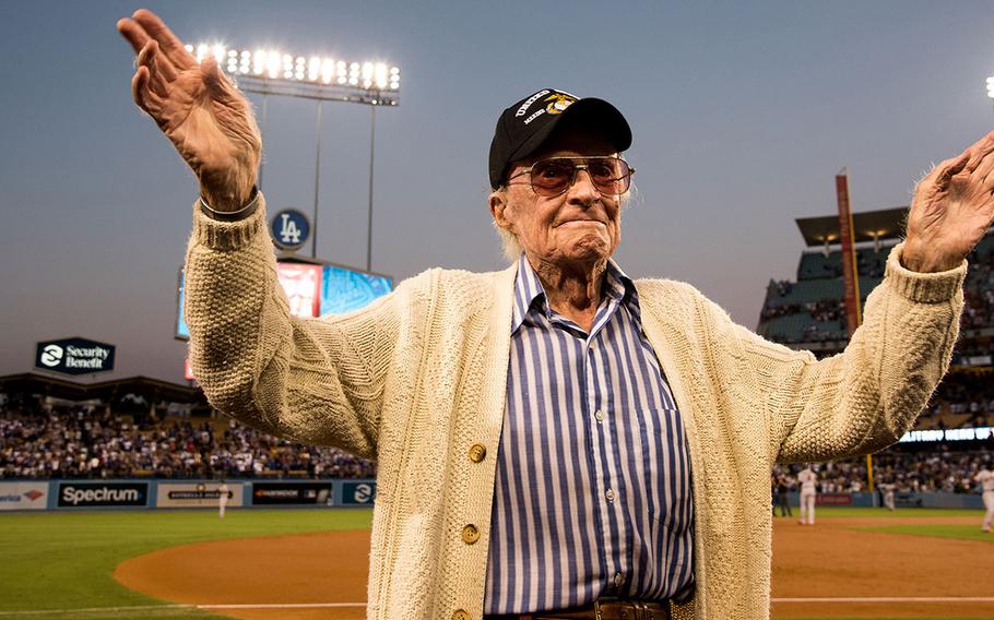 Marine veteran Sam Folsom, 98, who flew fighters at Guadalcanal in World War II, where he shot down three Japanese aircraft, and served later in the Korean War is honored on the field at Dodger Stadium Aug. 14, 2018.