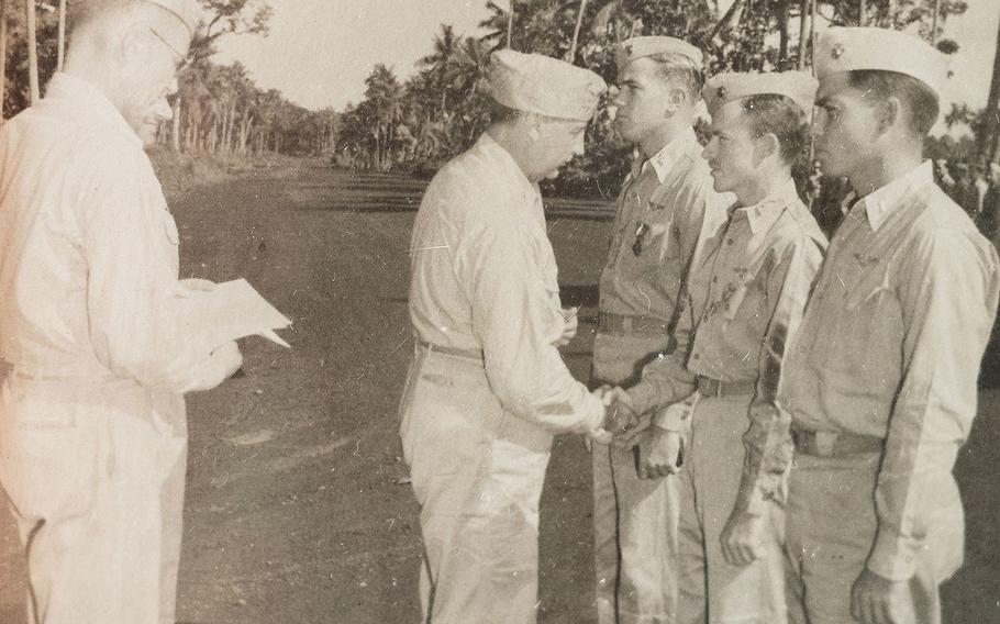 Second Lt. Sam Folsom, middle right, receives an award in this undated photo from World War II.