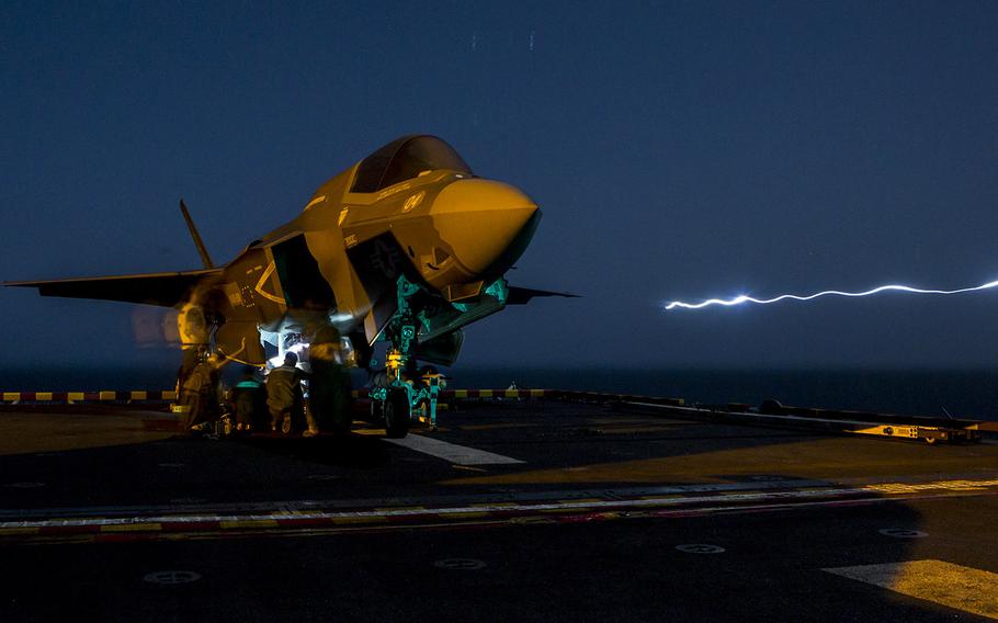 U.S. Marines with Marine Fighter Attack Squadron 211, 13th Marine Expeditionary Unit load ordnance into an F-35B Lightning II aboard the USS Essex in preparation for the F-35B's first combat strike, Sept. 27, 2018.