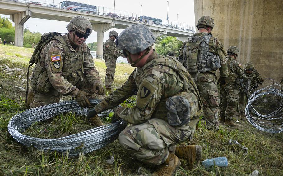 Soldiers from the 97th Military Police Brigade, and 41st Engineering Company, Fort Riley, Kansas, work with U.S. Customs and Border Protection at the Hidalgo, TX., port of entry, applying 300 meters of concertina wire along the Mexico border in support of Operation Faithful Patriot, November 2, 2018.