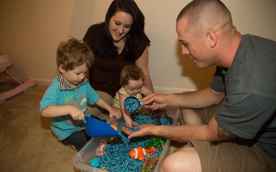 Emmett, Brooke, Emma Lynn and Cpl. Preston Fouch play with toys in Emmett's sensory room May 8, 2014. Emmett was diagnosed with Autism Spectrum Disorder in July 2013. TRICARE is currently evaluating treatment therapy options for children with autism.  