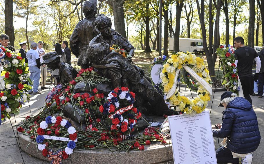 Visitors covered the Vietnam Women's Memorial in flowers for Veterans Day on Sunday, Nov. 11, 2018.