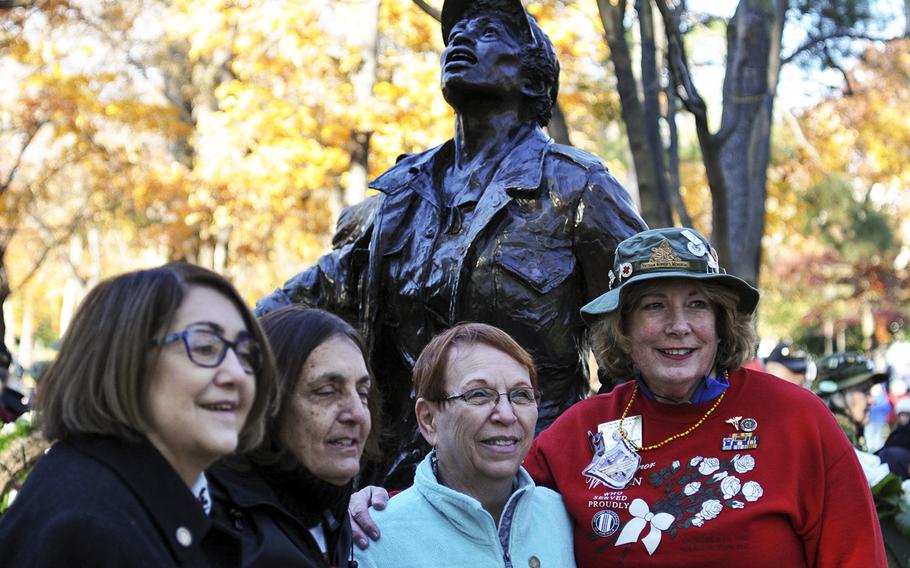 Women pose in front of the Vietnam Women's Memorial following a Veterans Day ceremony on Sunday, Nov. 11, 2018. About 60 Vietnam nurses traveled from across the country to attend the event, which marked 25 years since the memorial was established on the National Mall.