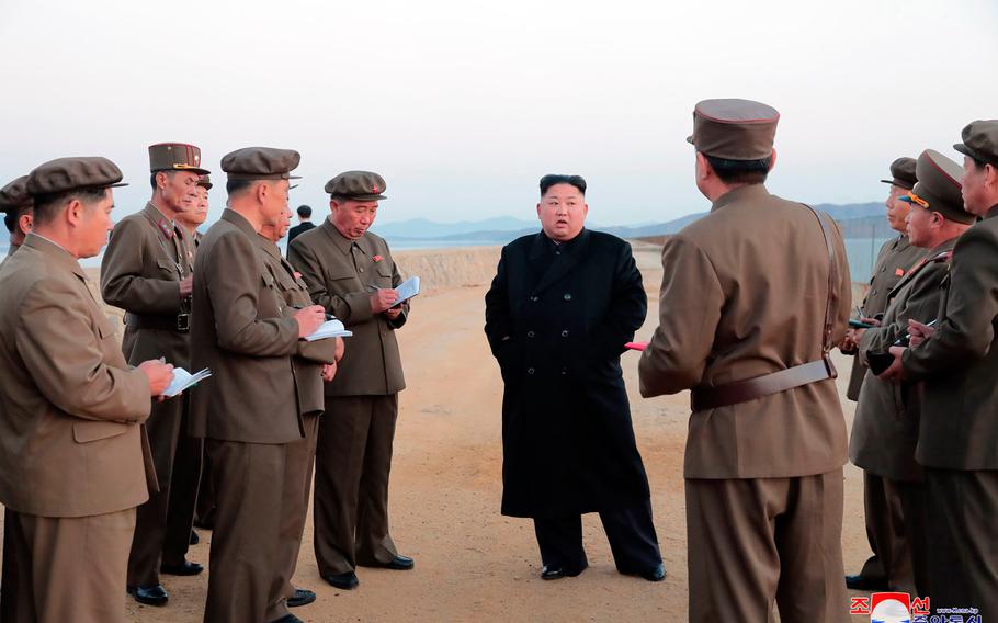 In this undated photo released Friday, Nov. 16, 2018, by the North Korean government, North Korean leader Kim Jong Un, center, listens to a military official as he inspects a weapon testing at the Academy of National Defense Science, North Korea. Kim observed the successful test of a "newly developed high-tech tactical" weapon, the nation's state media reported Friday, Nov. 16, 2018,  though it didn't describe what sort of weapon it was. Independent journalists were not given access to cover the event depicted in this image distributed by the North Korean government. The content of this image is as provided and cannot be independently verified. Korean language watermark on image as provided by source reads: "KCNA" which is the abbreviation for Korean Central News Agency.