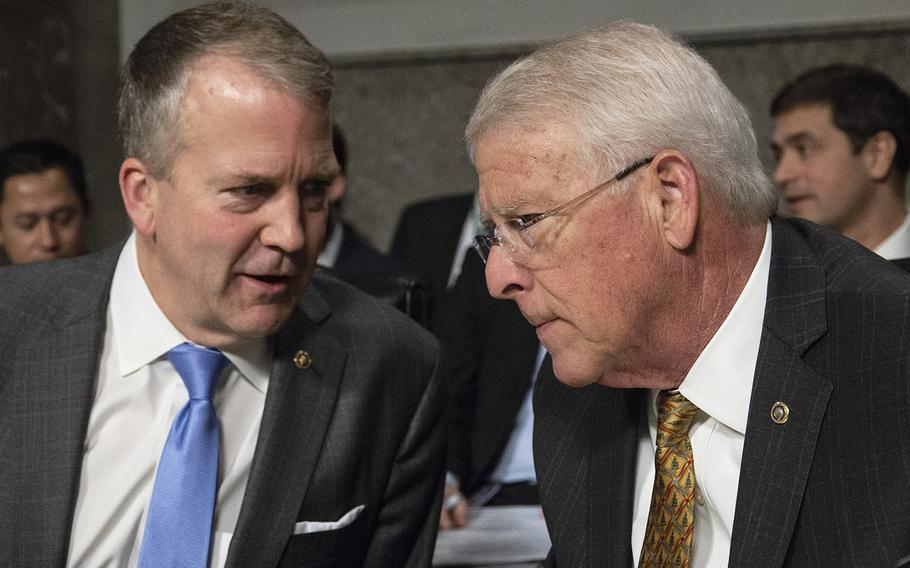 Sens. Dan Sullivan, R-Alaska, left, and Roger Wicker, R-Miss., confer before a Senate Armed Services subcommittee hearing on Navy and Marine Corps readiness, Dec. 12, 2018, on Capitol Hill. Sens. Roger Wicker, R-Miss., Angus King, I-Maine, and John Hickenlooper, D-Colo., announced Thursday, Aug. 19, 2021, that they have tested positive for the coronavirus