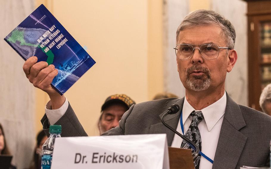 Dr. Ralph Erickson, a VA expert on post-deployment health issues, holds up a pamphlet addressing the Blue Water Navy veterans, while giving testimony on Aug. 1, 2018, at a Senate Veterans Affairs Committee hearing, as members heard arguments for and against the Blue Water Navy Vietnam Veterans Act. Erickson told senators most of the ailments presumed to be caused by Agent Orange also are tied to aging.