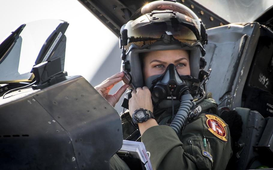 Capt. Zoe Kotnik clips on her mask in her F-16 Fighting Falcon prior to a sortie Nov. 2, 2017, at Eglin Air Force Base, Florida. On Monday, Feb. 11, 2019, just two weeks after taking command of the F-16 Viper Demonstration Team, Kotnik, was relieved as commander, officials said Tuesday.