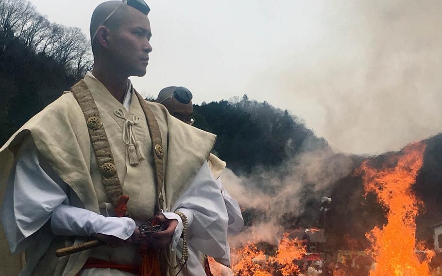 Buddhist monks set the stage for an annual fire-walking ritual at Mount Takao, Japan, Sunday, March 10, 2019. 