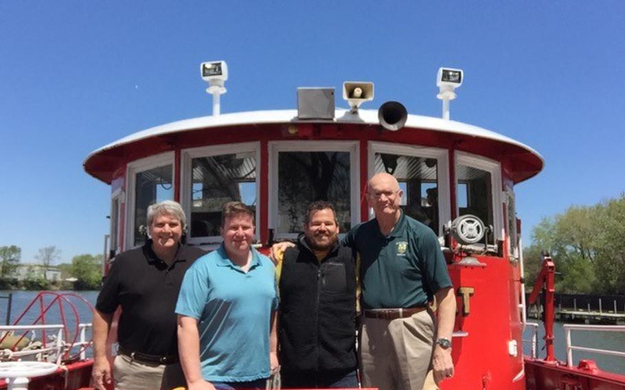 From left to right, Dale Eisenburg, Ray Novak, Erich Totsch and Charles “Lynn” Lowder aboard the “Fred A. Busse,” a 1930s-era Chicago fireboat, in May. With the help of Eisenburg and Lowder, Navy veterans Novak and Totsch purchased the boat, which they plan to use for commercial tours along the Chicago River.