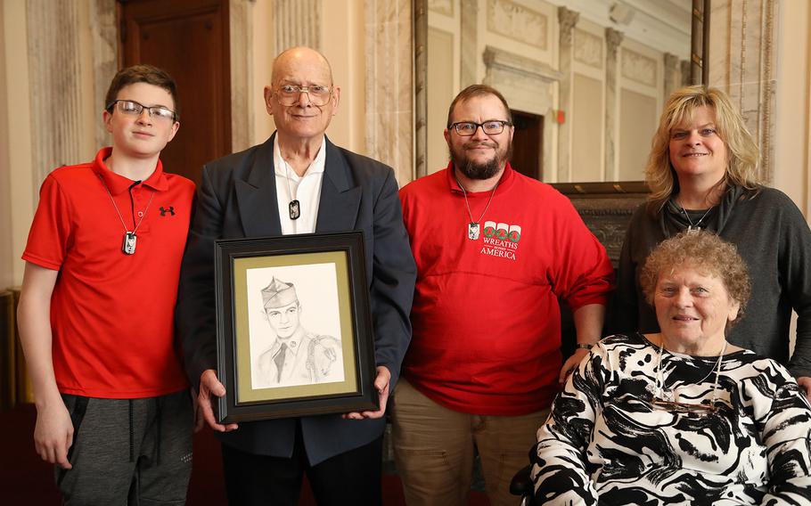 Clifton Sargent, holds a portrait of his brother Spc. 4 Donald Sargent, while surrounded by his family. From left: Brayden Kirk (Clifton’s grandson), Clifton’s son Donald Sargent, his daughter Jennifer Kirk, and wife Judith Sargent. 