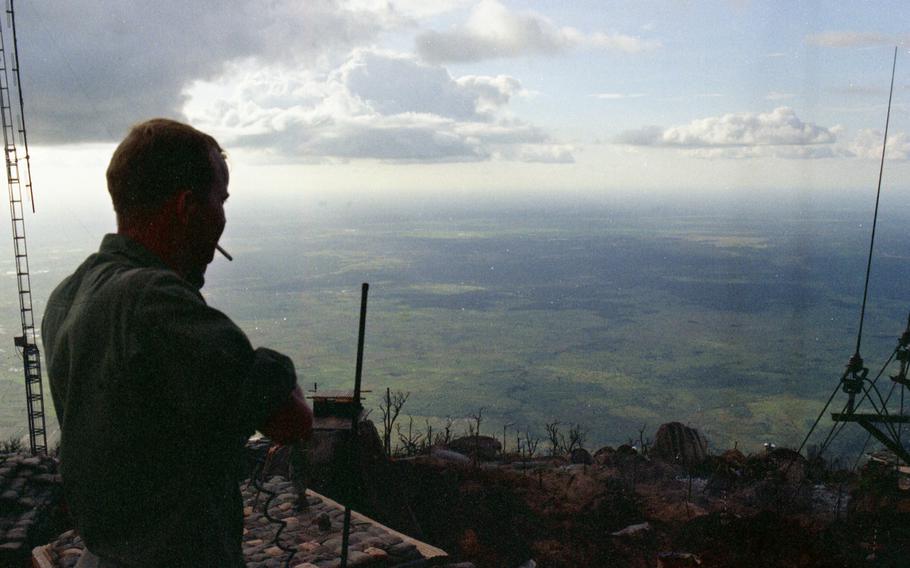 From a vantage point atop Nui Ba Den in Vietnam 1st Lt. John Lowe, 25 of Columbus, Ga., an artillery officer for 3rd Battalion, 22nd Infantry Regiment, 25th Infantry Division, spends a whole day in October 1969 calling in artillery on the mountain sides and surrounding flatlands. 