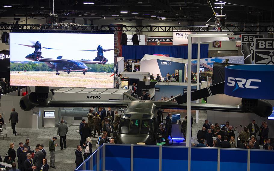 A video of a Bell V-280 Valor tilt-rotor aircraft in flight plays on the big screen above a static display of the aircraft which drew a steady stream of visitors at the 2019 AUSA convention in Washington, D.C., on Tuesday, Oct. 15, 2019.