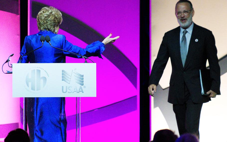 Former Sen. Elizabeth Dole, R-N.C., welcomes actor Tom Hanks on stage during the Heroes and History Makers gala Wednesday, Oct. 23, 2019 at The Anthem in Washington, D.C. Hanks is chairman of Hidden Heroes, a campaign of the Elizabeth Dole Foundation that brings resources to caregivers of veterans and service members. 