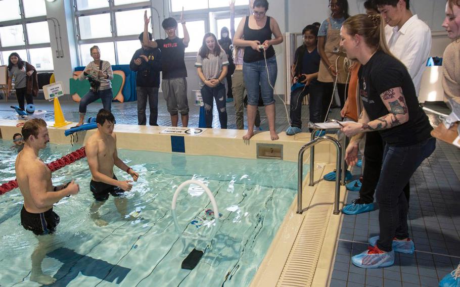 Students celebrate as their remotely operated underwater vehicle completes the final hurdle during a robotics challenge at Yokosuka Naval Base, Japan, Friday, Feb. 21, 2020.