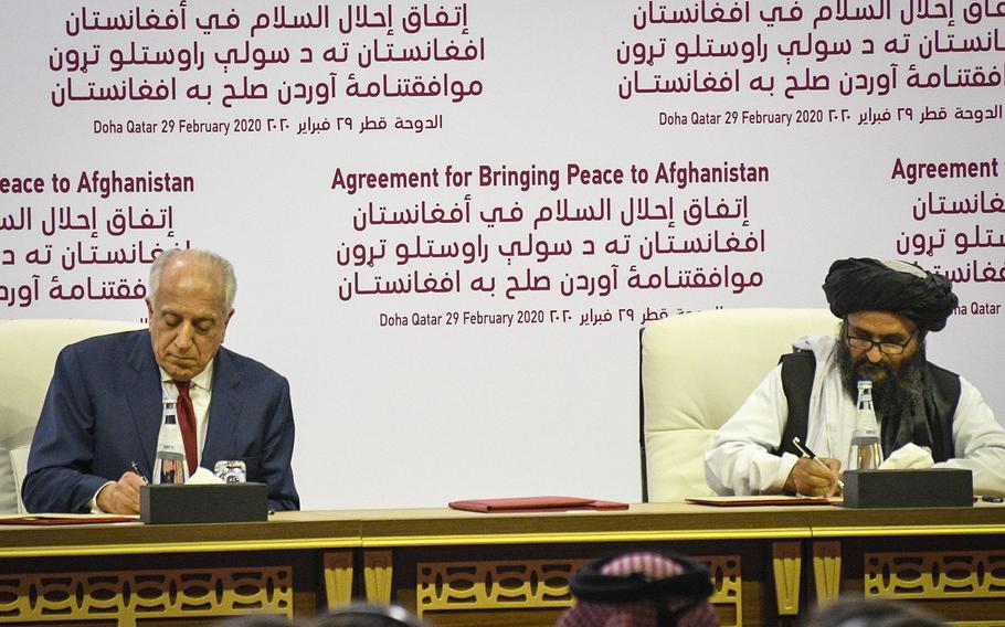Zalmay Khalilzad, America's special envoy for Afghan reconciliation, signs a peace deal with the Taliban, along with Mullah Abdul Ghani Baradar, the militant group's top political leader, in Doha, Qatar, on Saturday, Feb. 29, 2020.