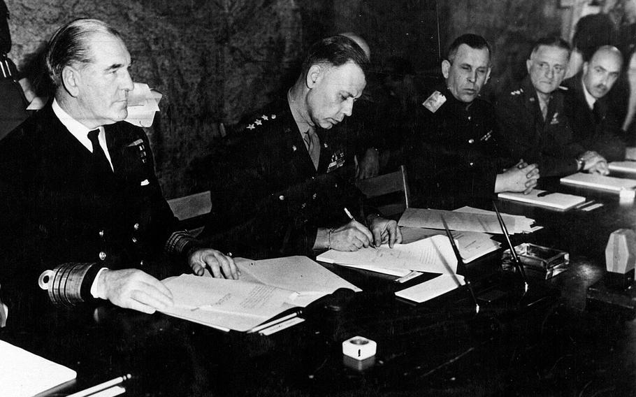 U.S. Lt. Gen. Walter Bedell Smith, chief of staff to General of the Army Dwight D. Eisenhower, Supreme Commander-in-Chief Allied Expeditionary Force signs on behalf of the Allied High Command the document of unconditional surrender of Germany, after it had been signed by the representatives of the German government sitting at the table across from him. The unconditional surrender of Germany was signed at 2:41 a.m. May 7, 1945, at Supreme Headquarters Allied Expeditionary Force, Forward Headquarters, at Reims, France. On Smith's right is British Adm. Harold M. Burrough, commander-in-chief, Allied Naval Expeditionary Forces, and on his left are Maj. Gen. Ivan Susloparoff, of the Russian Artillery, who signed the document on behalf of the Soviet High Command, and Gen. Carl A. Spaatz, commanding general, U.S. Strategic Air Forces.

