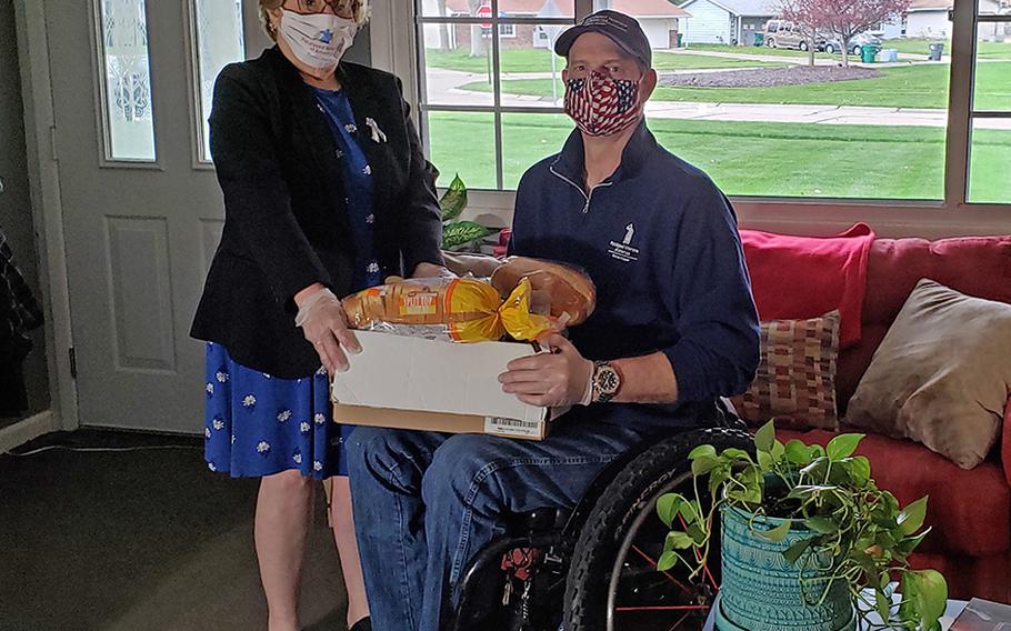Sharon Moster, executive director of the Ohio chapter of Paralyzed Veterans of America, delivers food to a veteran. Since the pandemic began, Moster has seen significant demand for help getting groceries.