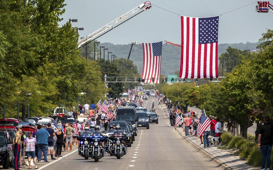 People line Abbot Drive to pay their respects to Marine Cpl. Daegan Page as the procession carrying his body drives through Omaha, Neb. on Friday Sept. 10, 2021. Page was one of 13 U.S. service members killed Aug. 26 in the bombing at the Kabul airport, which also killed at least 169 Afghans. 