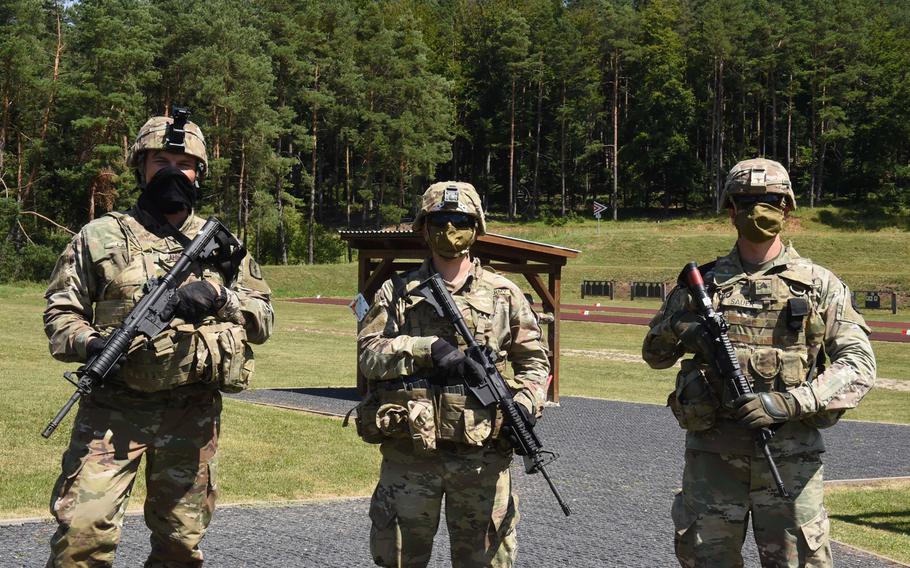 From left, First Lt.Jeremy Lahn, a health services officer with the 30th Medical Brigade, Pfc. Griffin Emrick, a combat medical specialist with the Joint Multinational Readiness Center, and Sgt. Jason Sauer, a chemical, biological, radiological and nuclear specialist with the 41st Field Artillery Brigade, gather during the U.S. Army Europe, Best Warrior Competition on July 27, 2020, at Hohenfels, Germany.