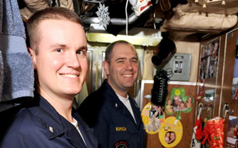 Lt. j.g. Will Fowler, left, Lt. j.g. Gabriel Kimich, right, and one more junior officer share a stateroom aboard the USS Seawolf. Kimich says he considers himself lucky to be able to get some privacy when his roommates are working. When Kimich first arrived, he slept in an 18-man berth.
