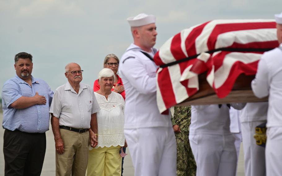 Orville Staffenhagen, second from left, brother of Navy Fireman 1st Class Neal Todd, stands at attention as his brother's remains are escorted from an airliner by a United States Honor Guard to a waiting hearse at Minneapolis/St. Paul International Airport on Thursday, July 8, 2021. Standing next to Staffenhagen is his son Anthony, left, and his wife, Delores. Todd was killed while stationed aboard the USS Oklahoma during the Japanese attack on Pearl Harbor on Dec. 7, 1941. His remains were positively identified through DNA samples in February of this year. 