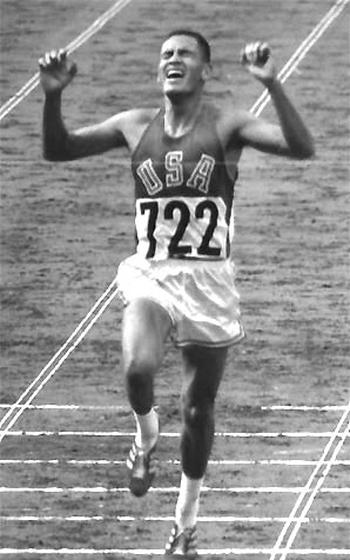 Billy Mills crosses the line with a win in the 10,000-meter race at the 1964 Olympics in Tokyo.